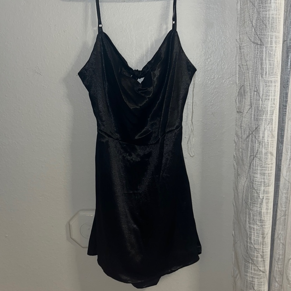 Shiny little black dress with open bow back